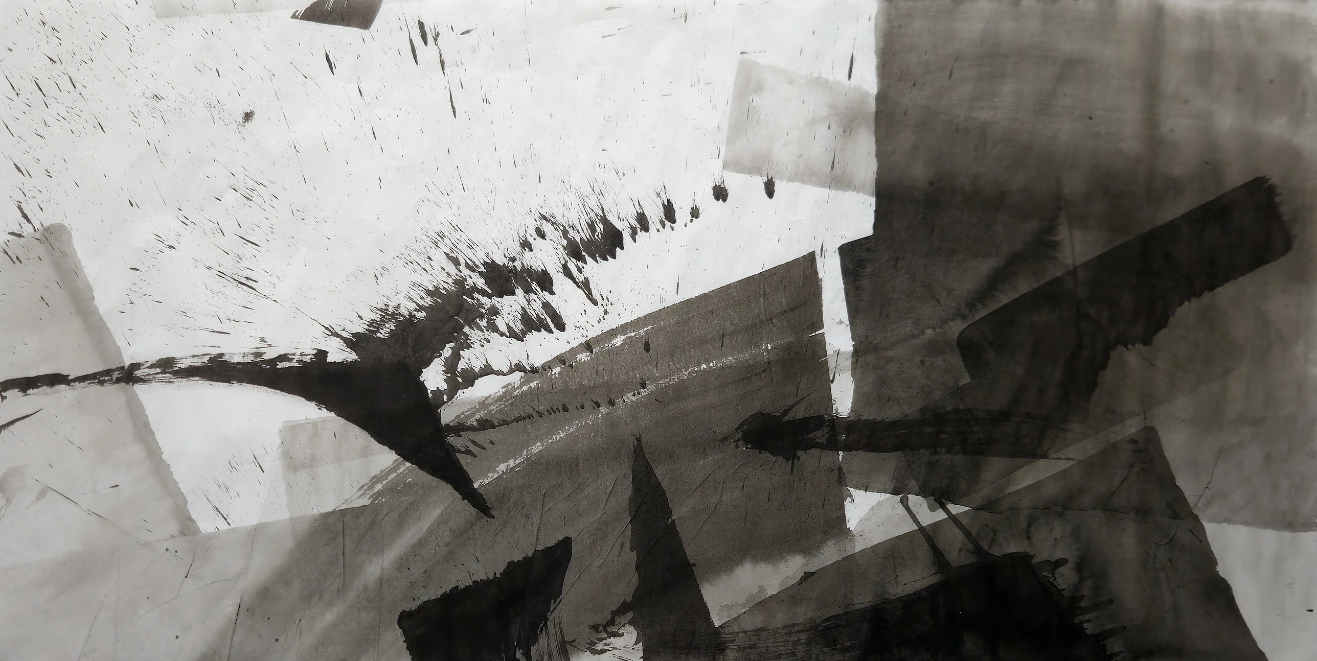 A curved black stroke sweeps from the left beneath spattered white paper, with overlapping grey and black rectangles massed across the right and bottom.