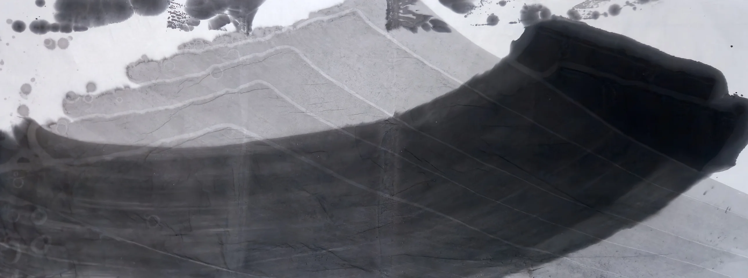 A broad dark band curves from lower left to a squared black end at right, beneath pale grey stepped washes and blots along the top.
