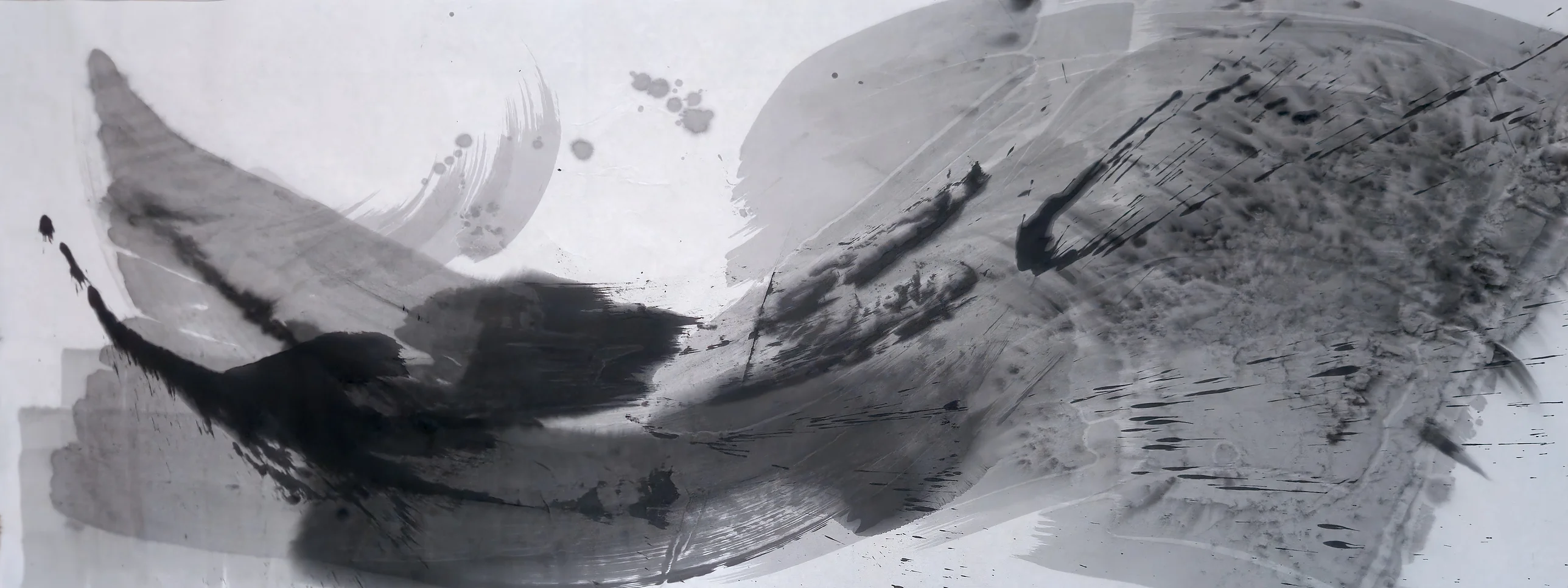 Wide grey and black ink painting: dark sweeping strokes at lower left rise toward a large mottled grey mass with dark streaks on the right.