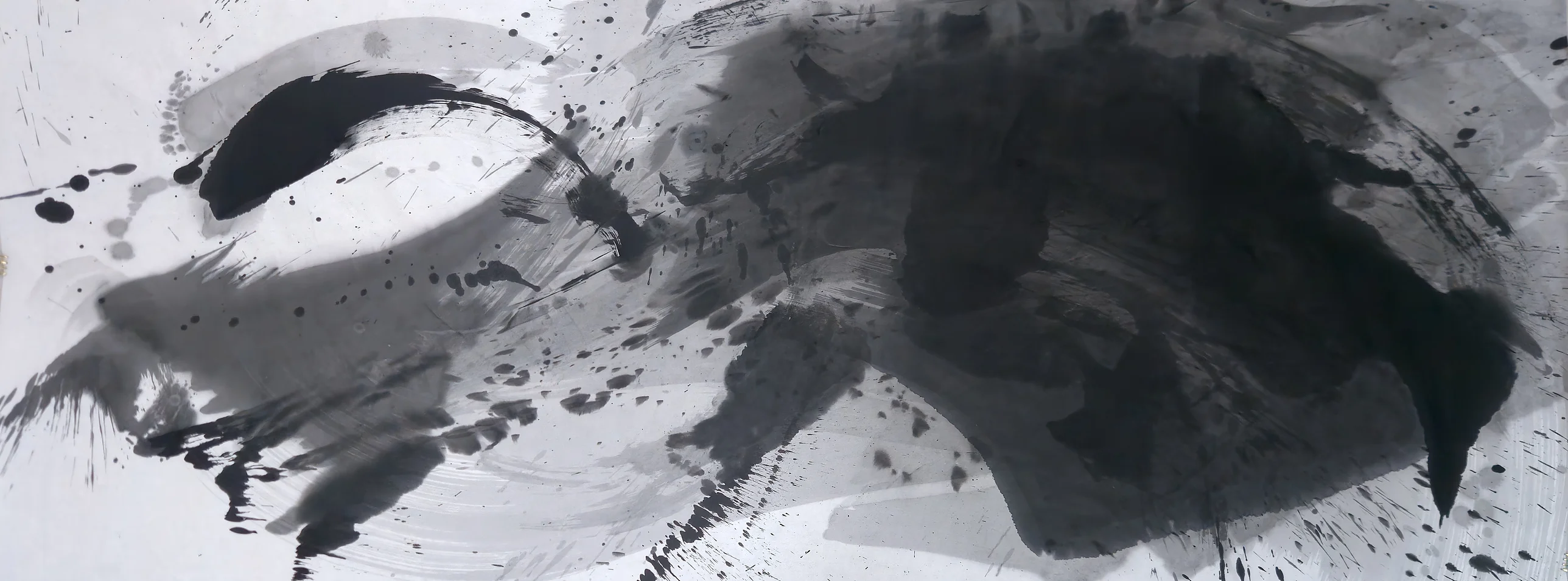 Wide black and grey ink painting: a black crescent upper left, pale sweeping grey arcs, spatter, and a large dark mass filling the right half.
