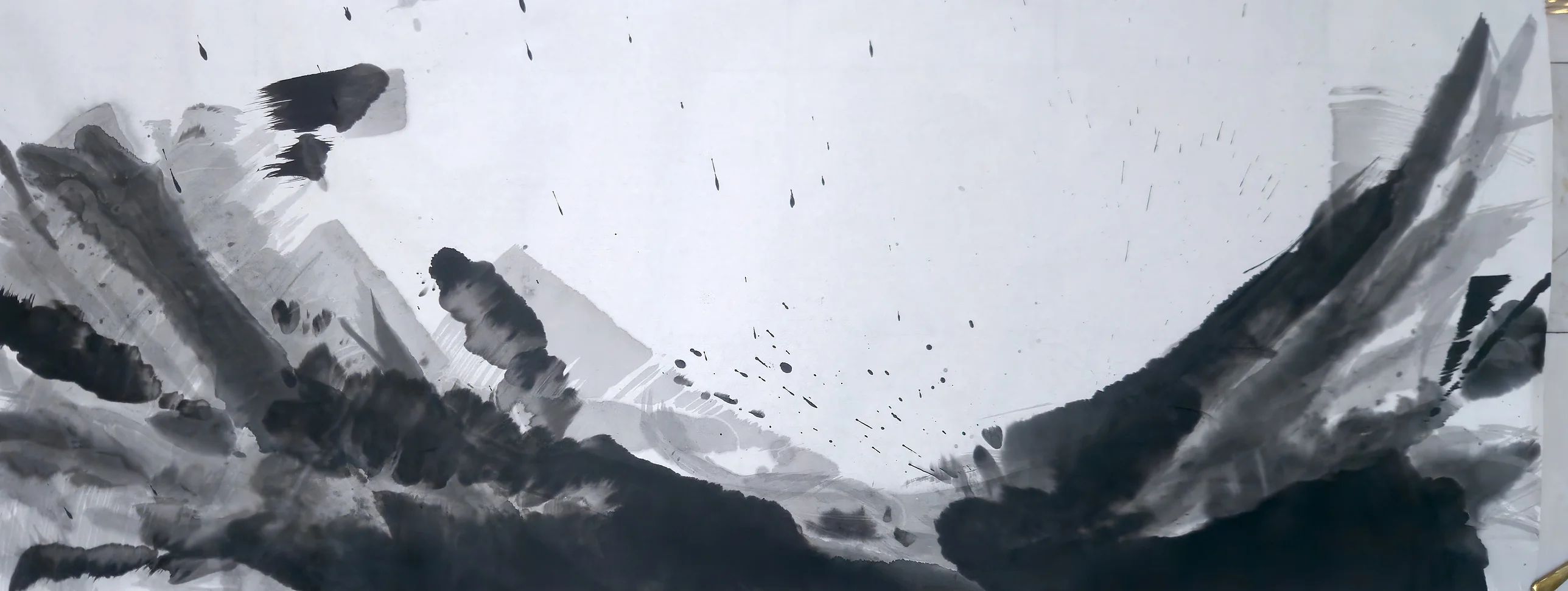 Wide ink landscape: dark masses rise from both lower corners in a bowl shape, grey diagonals at left, spatter across pale open sky.