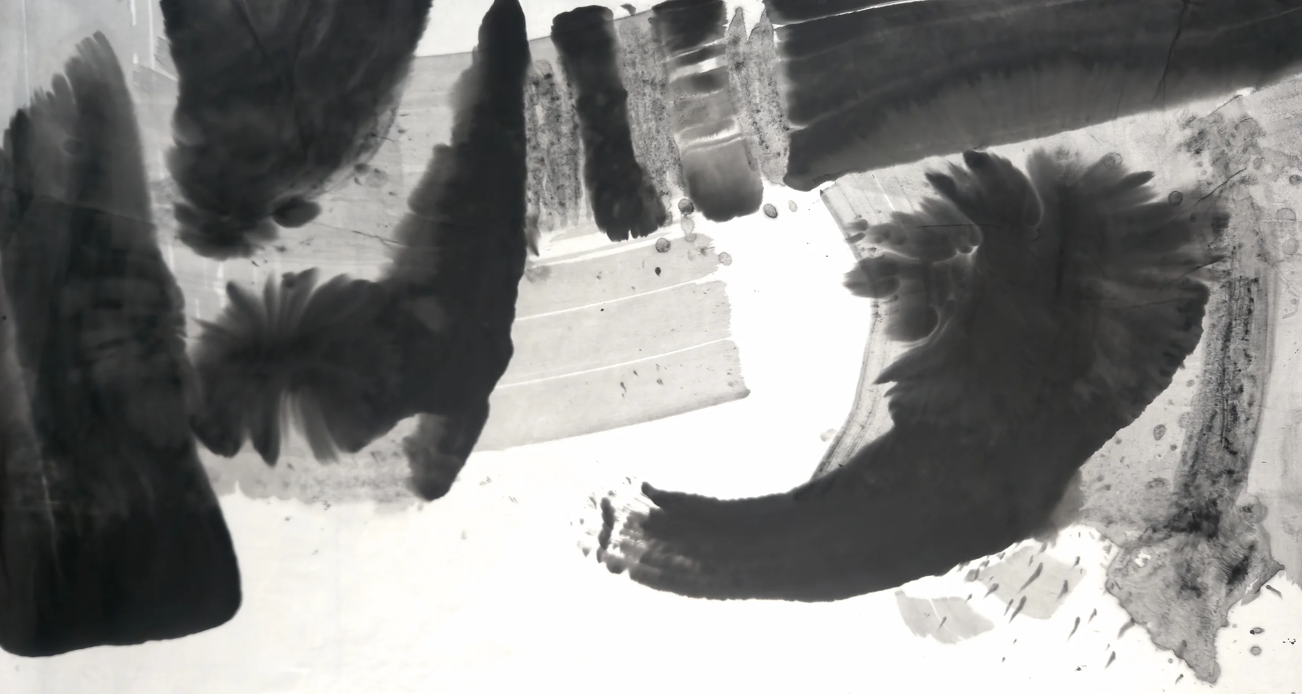 Black and grey ink shapes: a dark slab at left, blocks along the top, a curved feathered stroke around white space at right.
