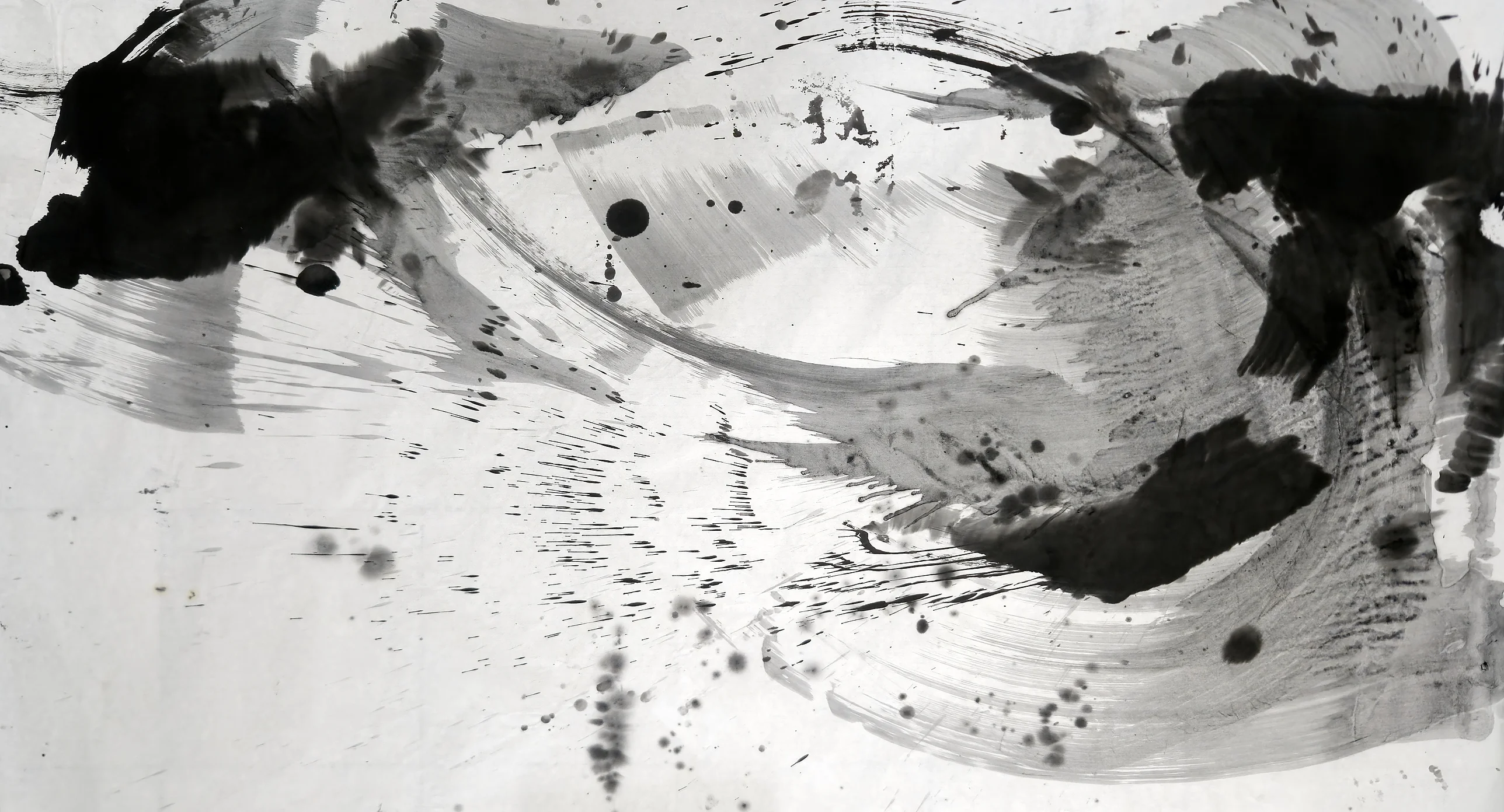 Wide ink painting: grey sweeping arcs in a rough circle, black masses at top left, top right and lower right, spatter across pale lower left.