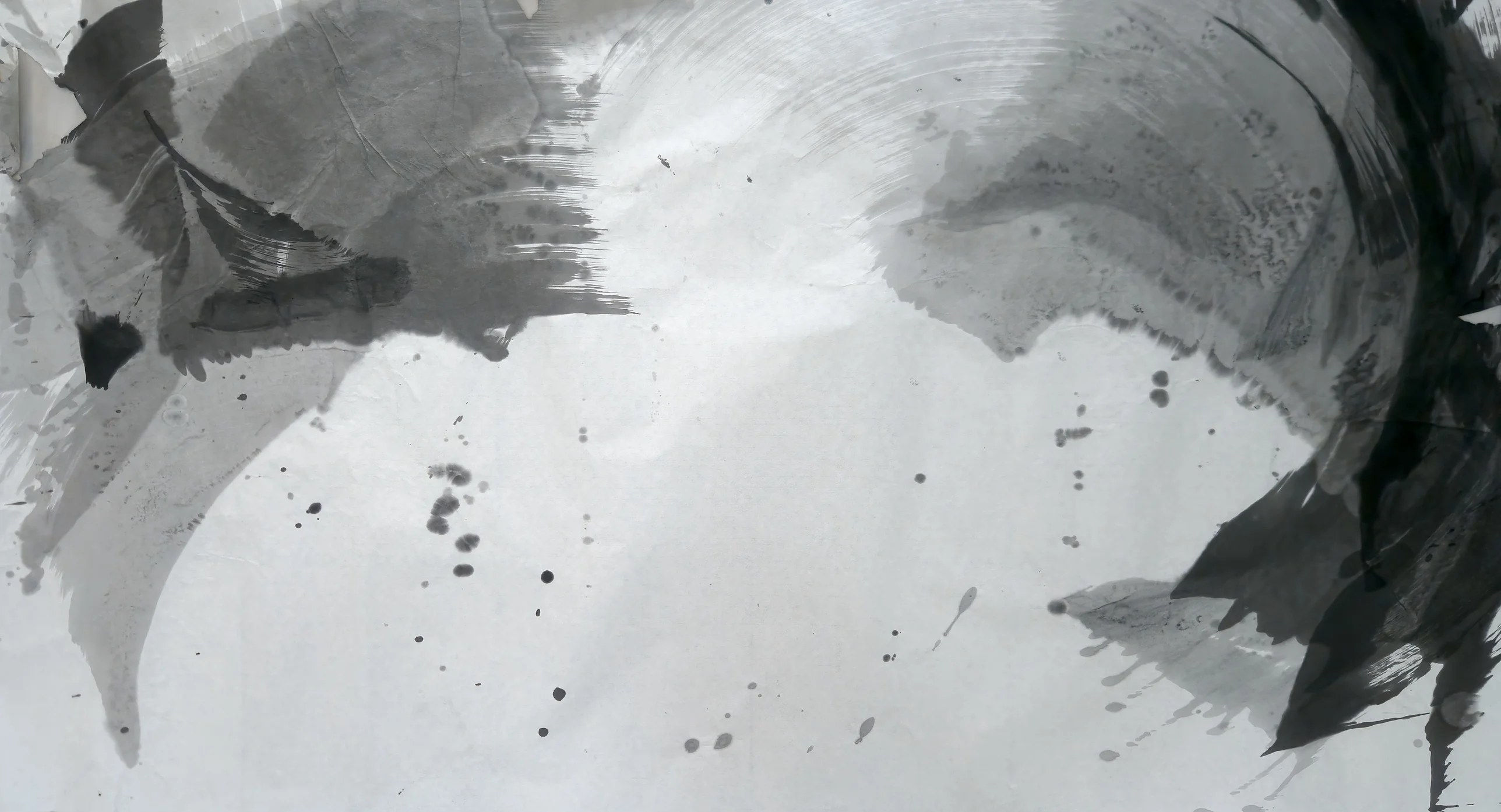 Grey washes upper left, jagged black mass at the right edge, a pale arc across the top, dark drips scattered over an empty pale centre.