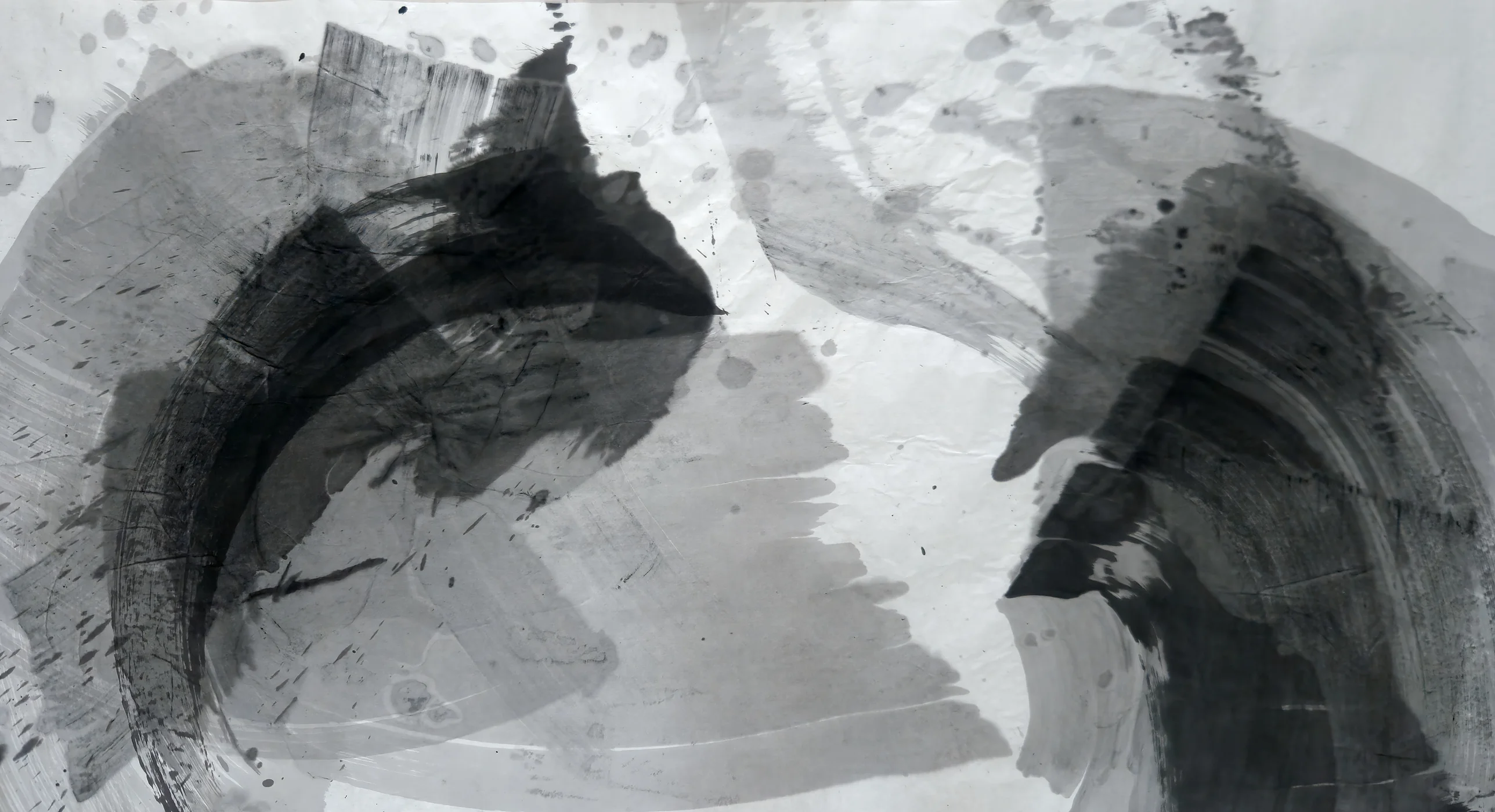 Wide ink painting in black and greys: a dark arc at left and a dark arc at right face each other across a pale, drop-spotted centre.