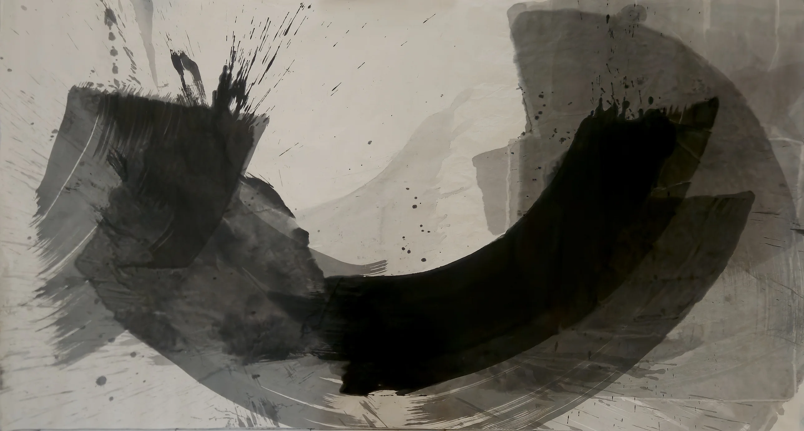 Black crescent sweeping from lower centre to upper right over grey arcs, a dark spattered block at left, pale paper open above.
