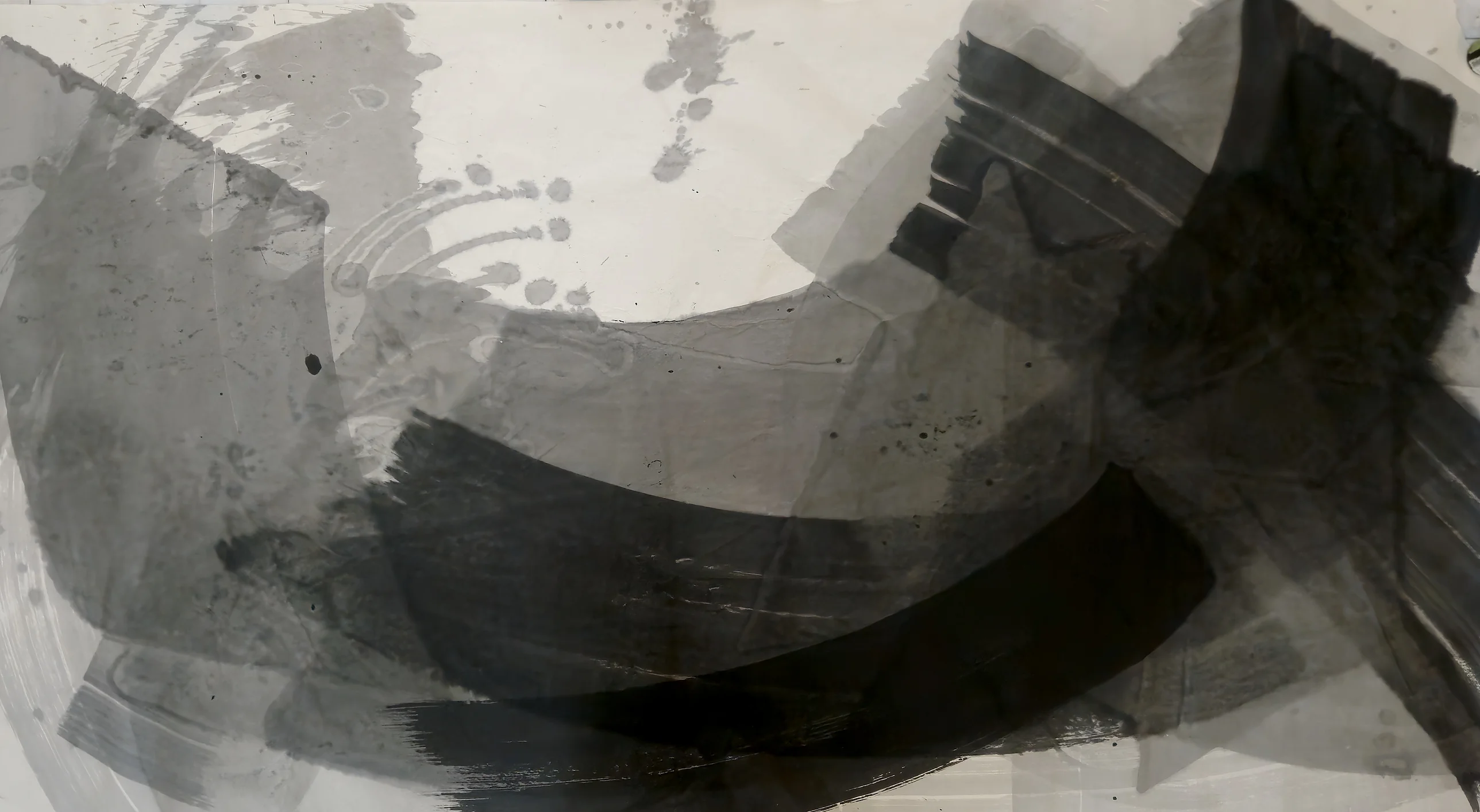 Broad grey and black brushed arcs sweep from lower left to a dark block at upper right, under a pale cream bowl dotted with drips.