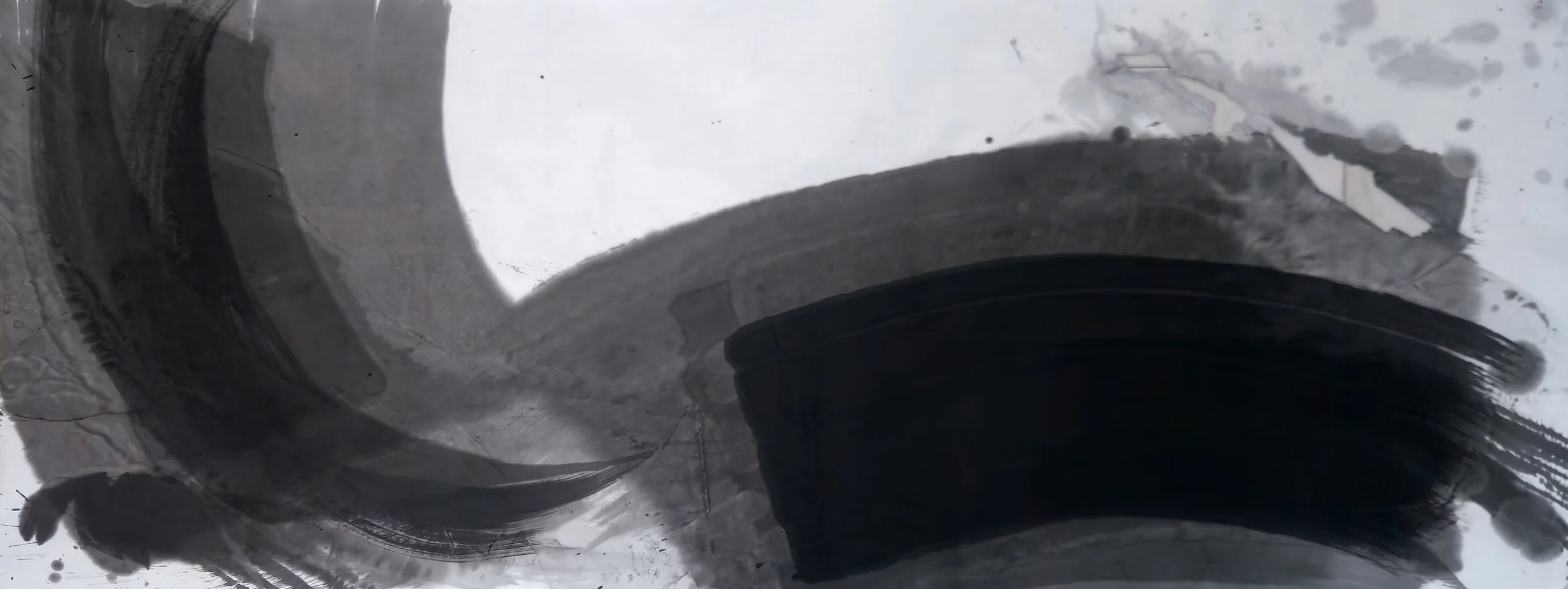 Wide grey ink crescent on the left curving into a grey band across the right, a dense black block lower right, white paper top centre.