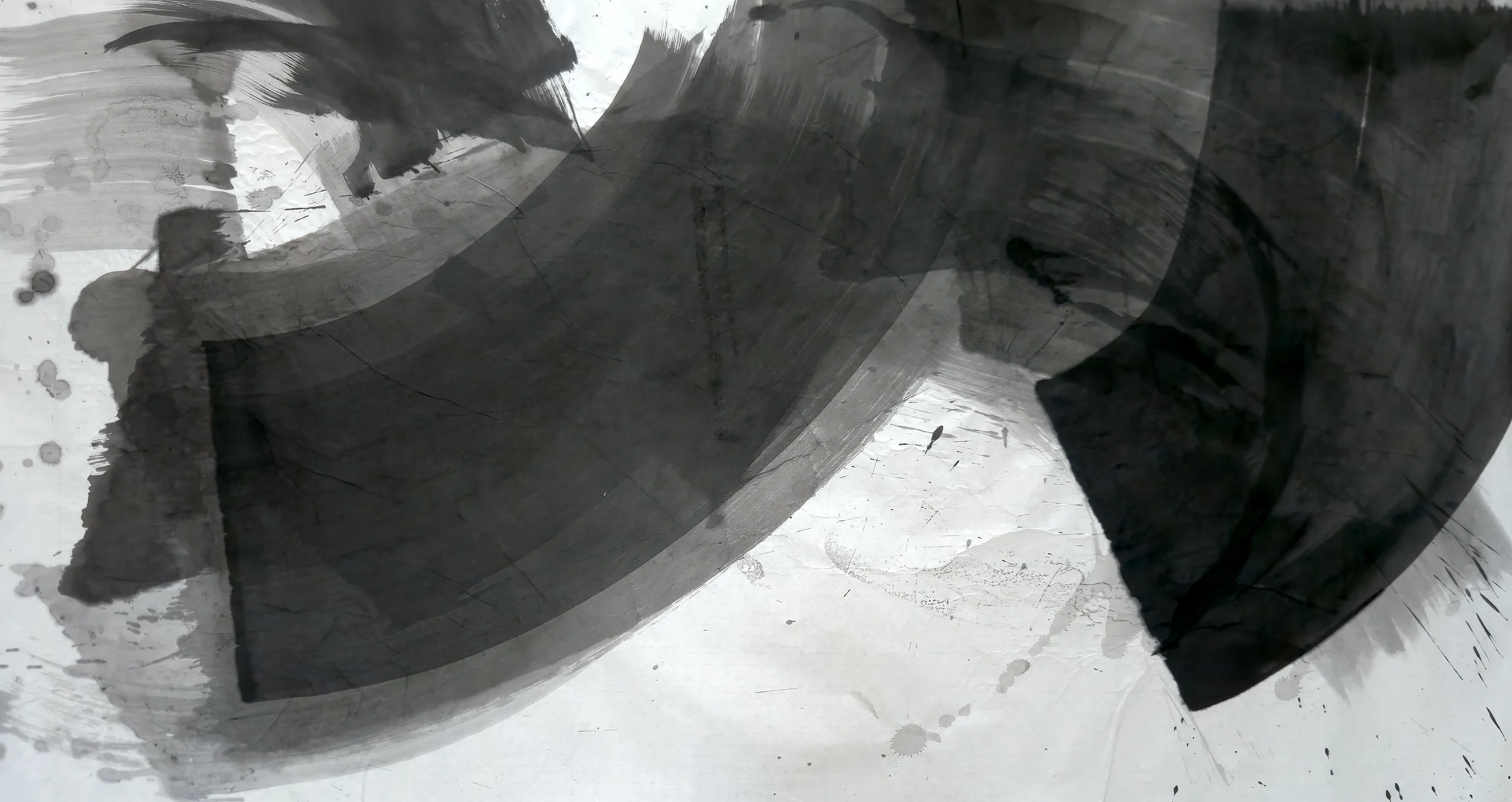 A wide grey arc sweeps from a squared left end across the top, meeting a black curved wedge at right, white paper below with drips.
