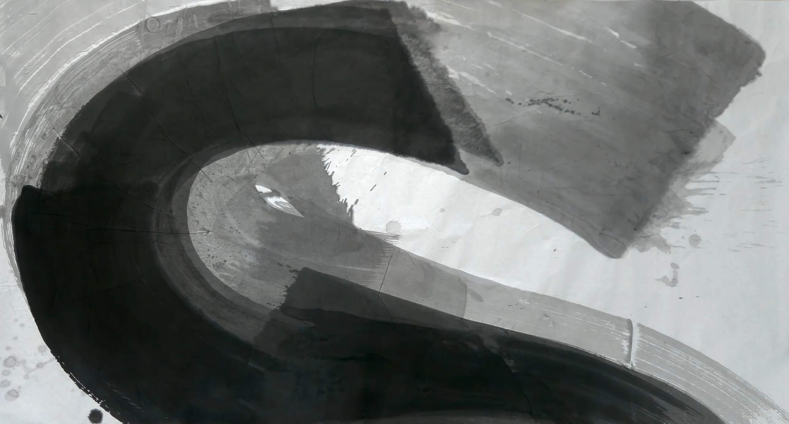 A broad black S-curve sweeps across a wide sheet, with a grey rectangle at upper right and a white band of paper inside the curve.