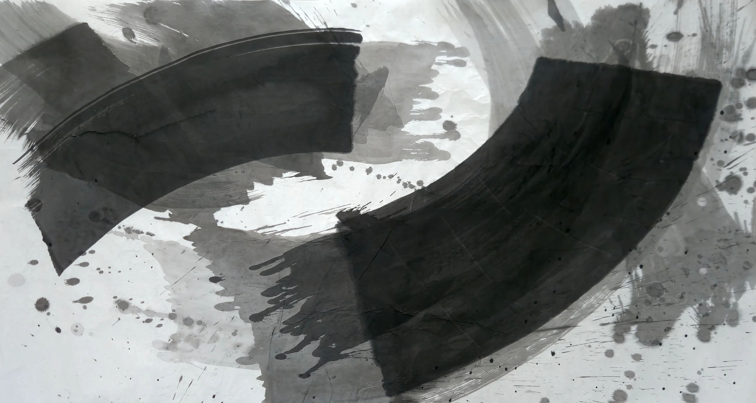 Two broad black curved bands, upper left and lower right, arc around a white centre over grey washes, with ink spatter along the right edge.