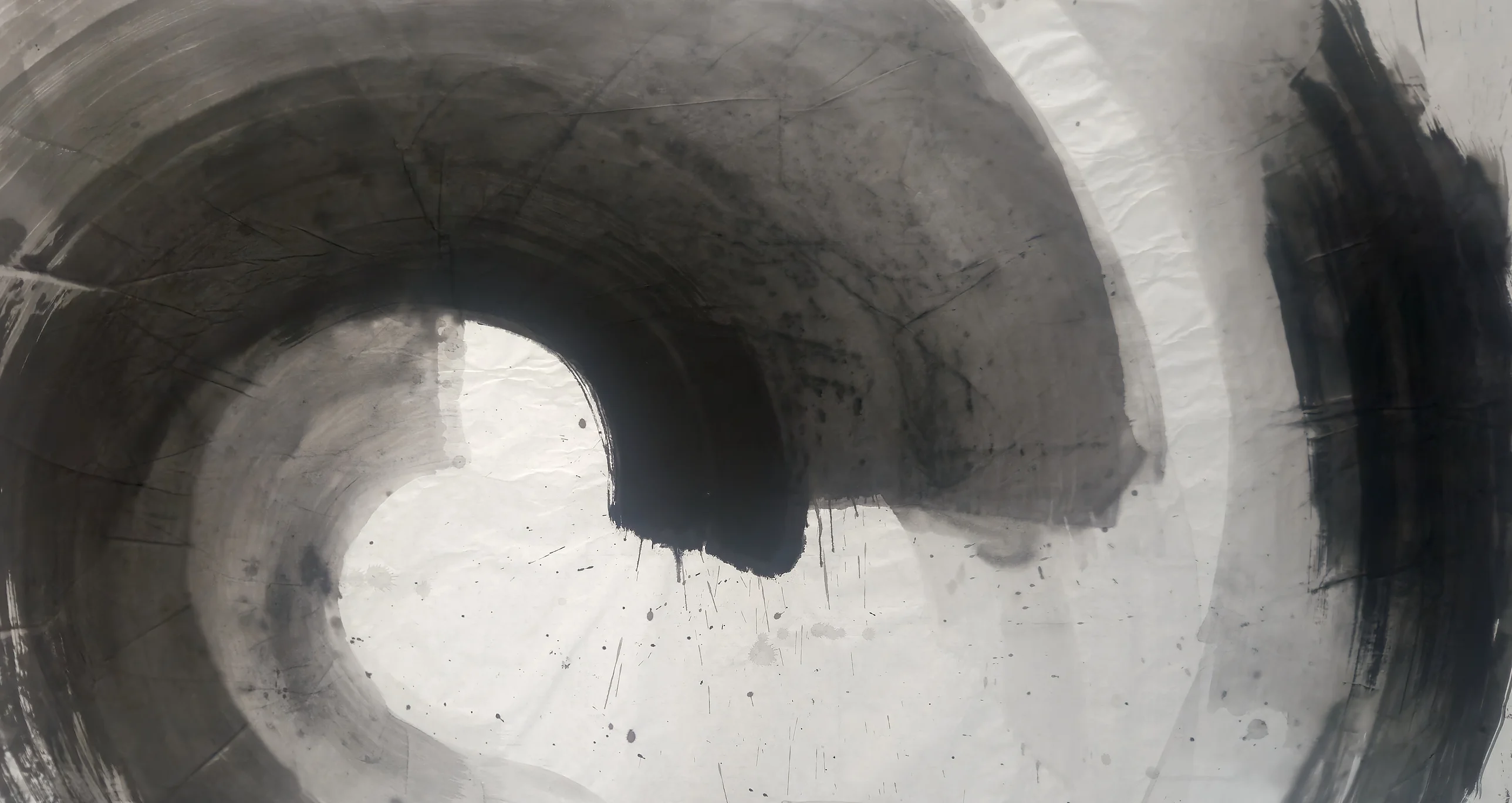 A wide grey spiral curls around a white centre, with a black hook dripping at its end and a dark vertical stroke at right.