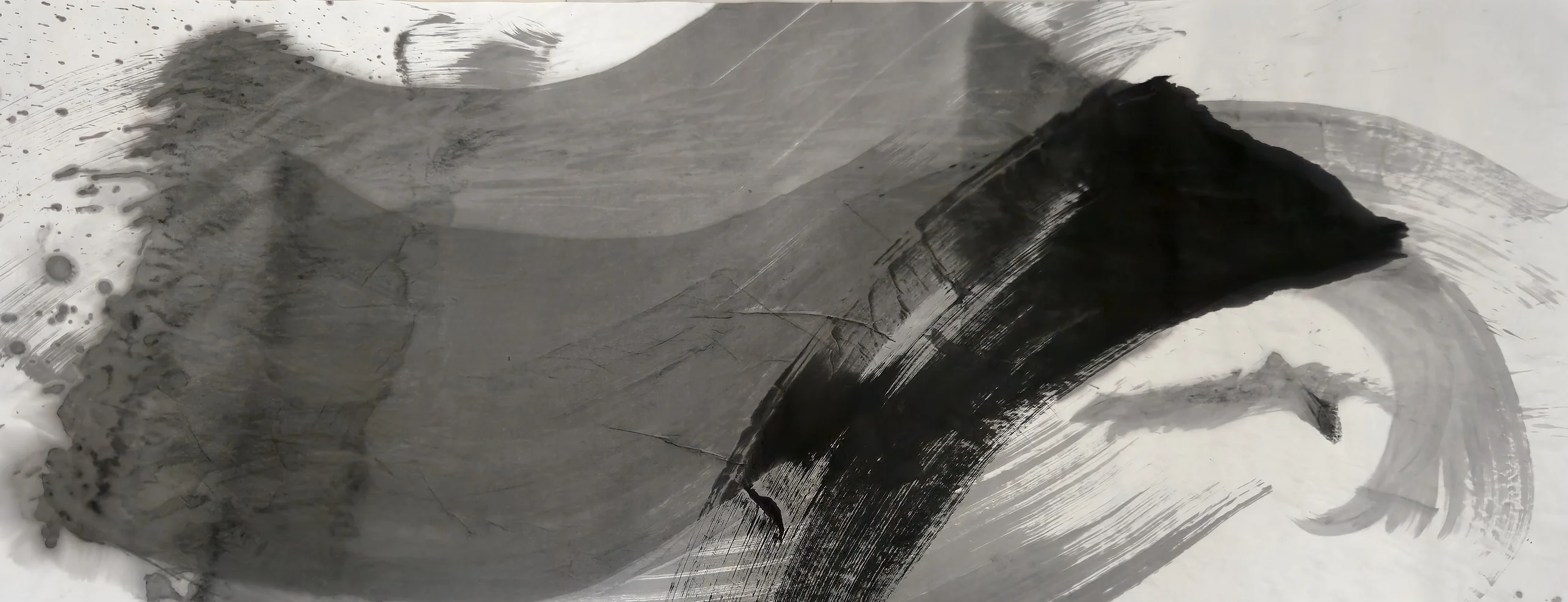 A wide grey band sweeps right into a thick black curved stroke, with pale grey arcs beyond it and spatter at top left.