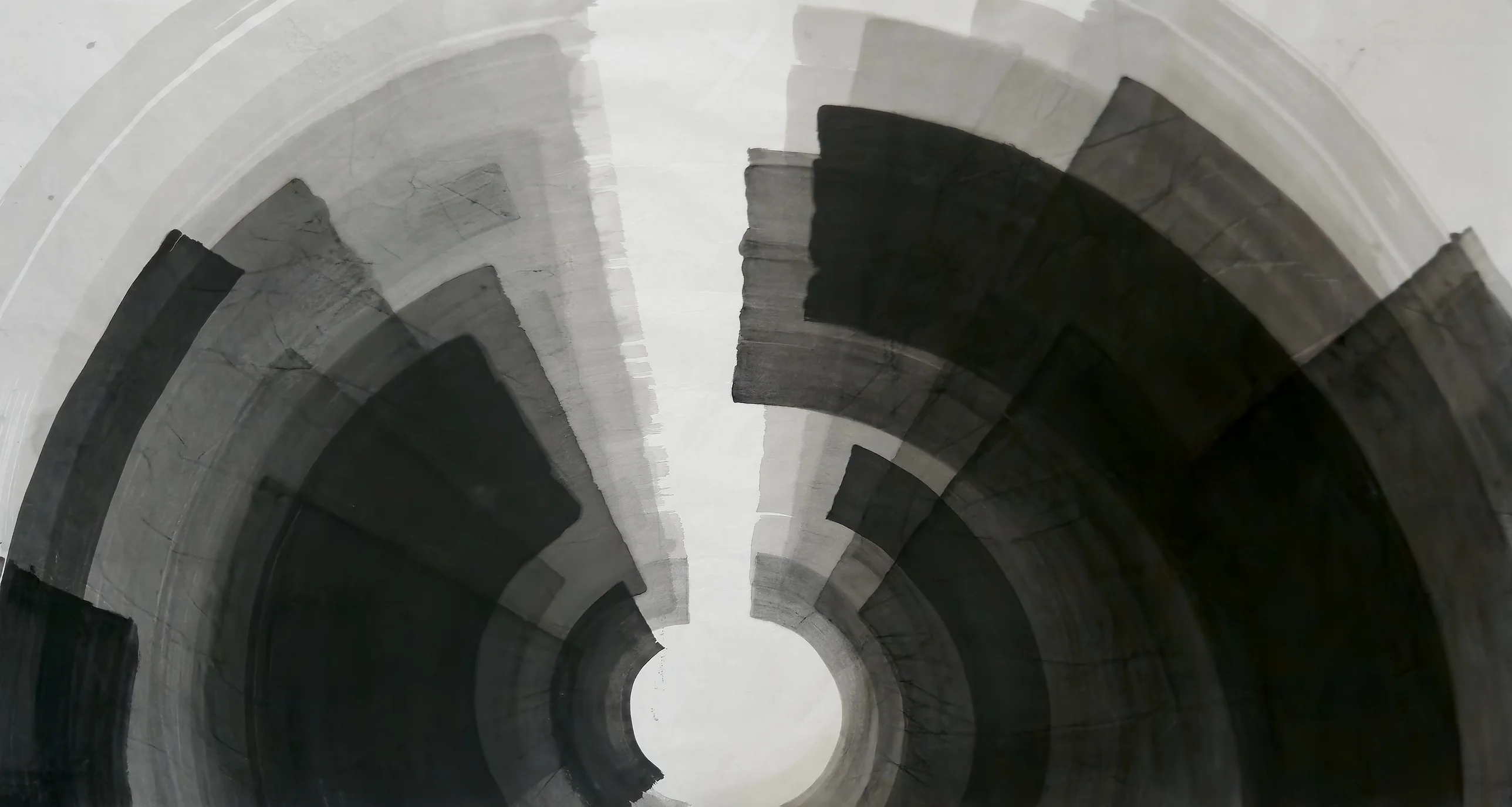 Two fans of grey and black curved bands encircle a small white circle at bottom centre, divided by a pale wedge descending from the top.