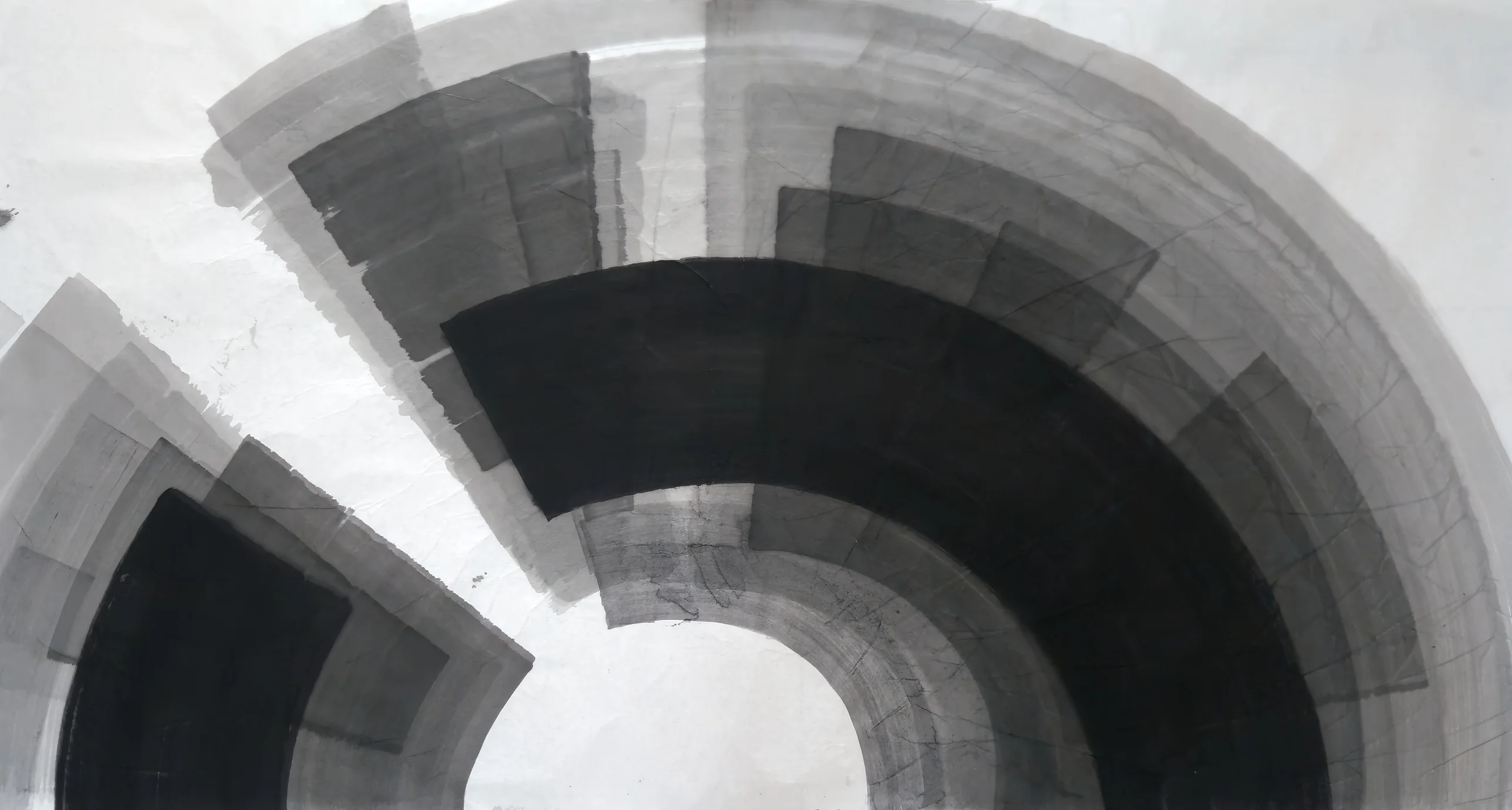 Concentric grey and black arc bands sweep around a white opening at bottom centre, with a separate black and grey sector at lower left.