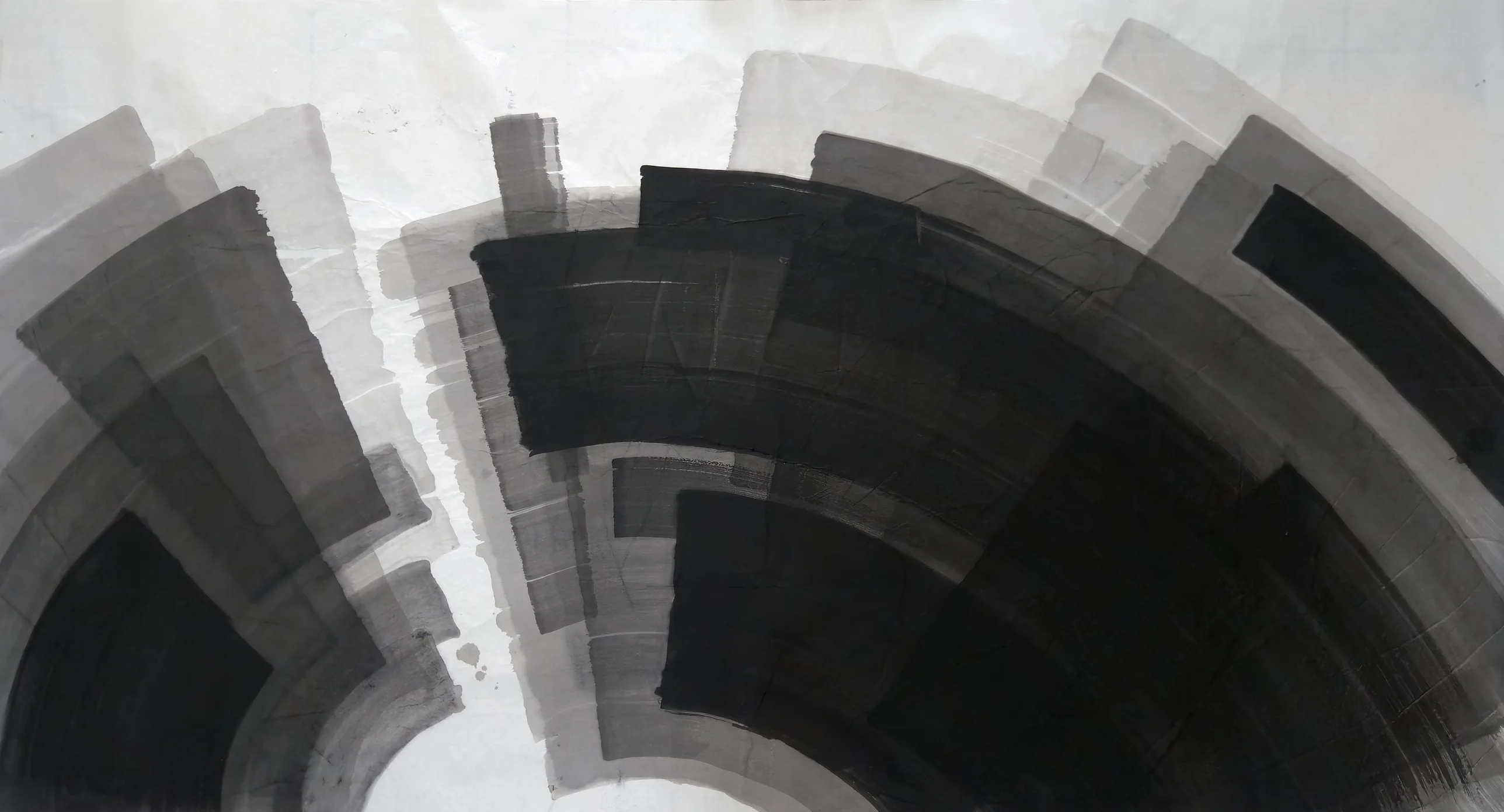 Curved black and grey bands radiate around a white arch at bottom centre, darkest at lower right, with pale paper across the top.