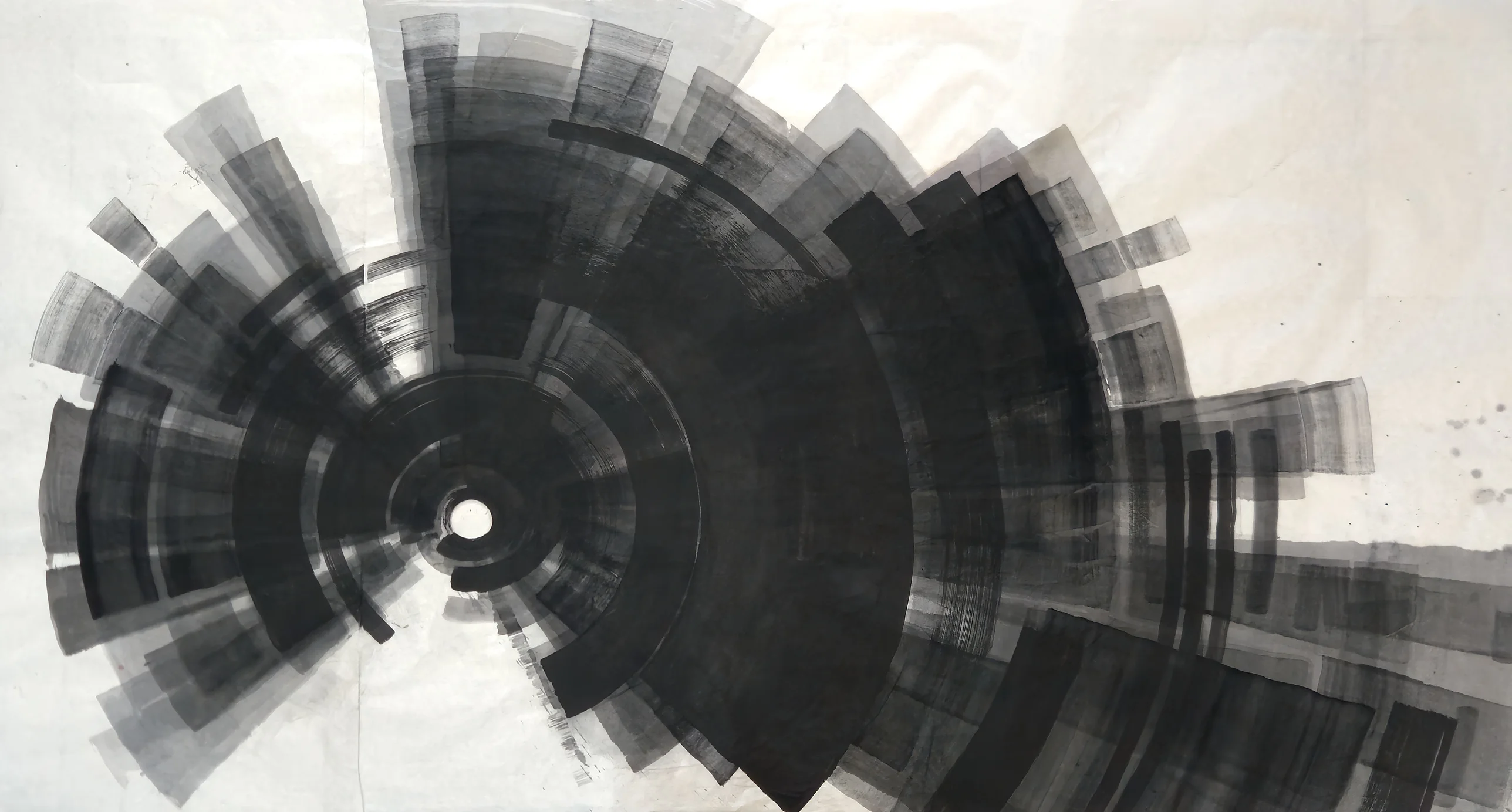 A black and grey spiral of arcs and rectangular brush blocks around a small white circle left of centre, with a dark band extending right.