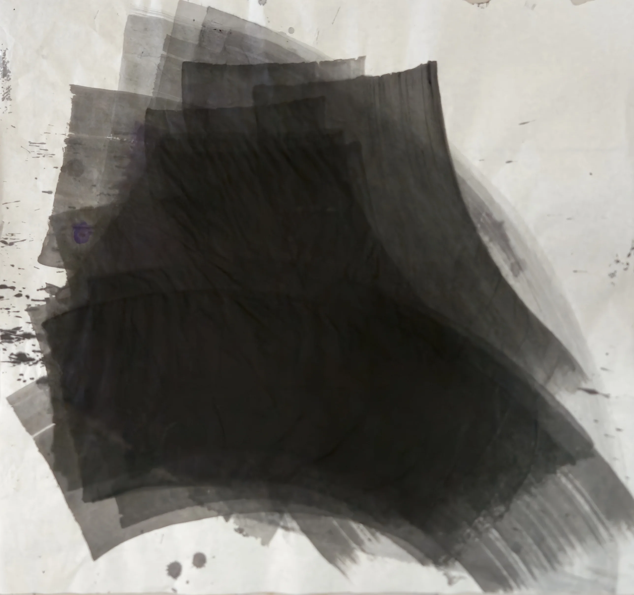 A large black mass of stacked curved grey bands sweeps toward the lower right on pale paper, with spatter at left and drops below.