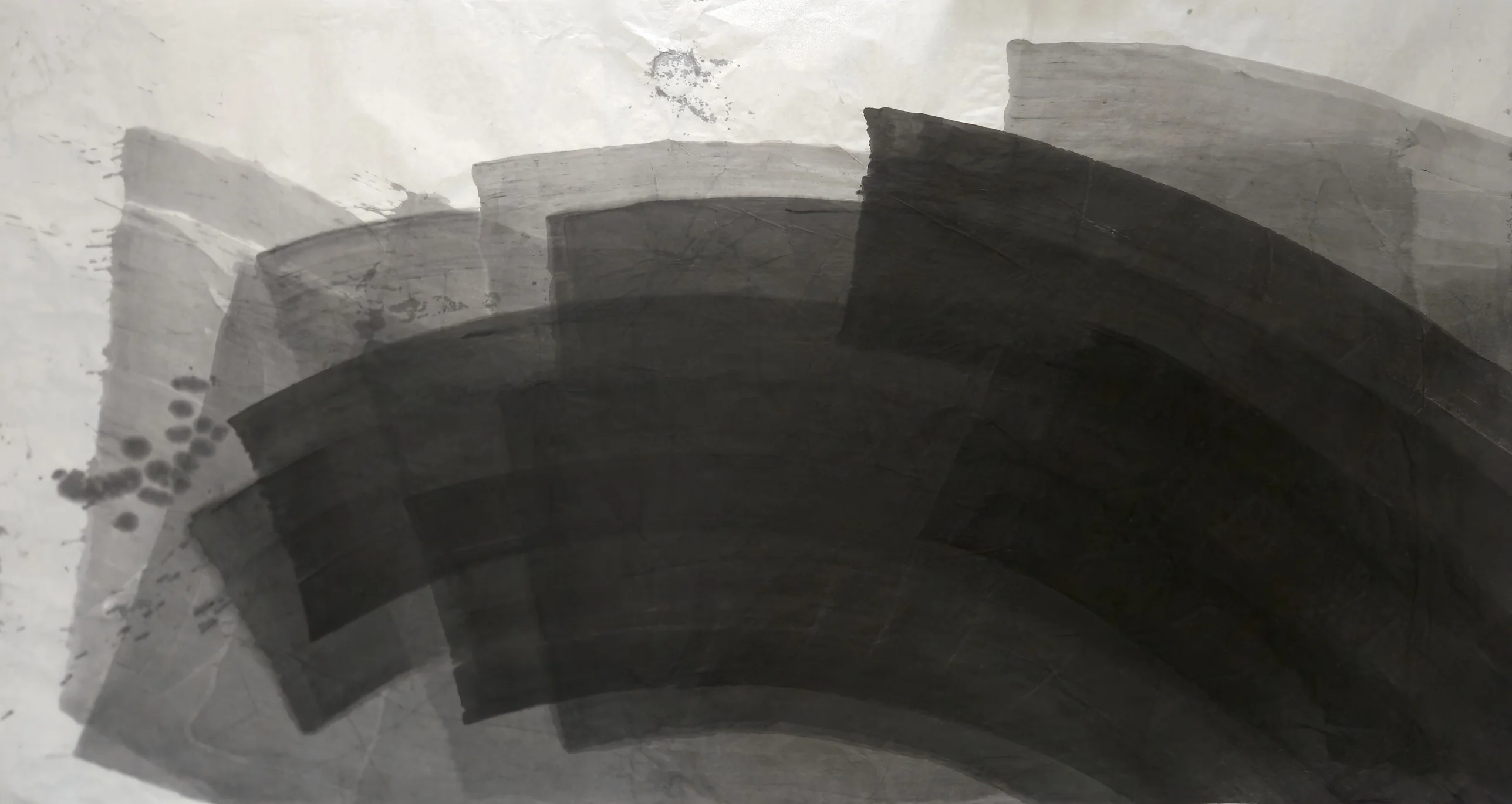 Wide sheet of broad grey and black curved bands sweeping from lower left to upper right, darkest at lower right, dot cluster at left.