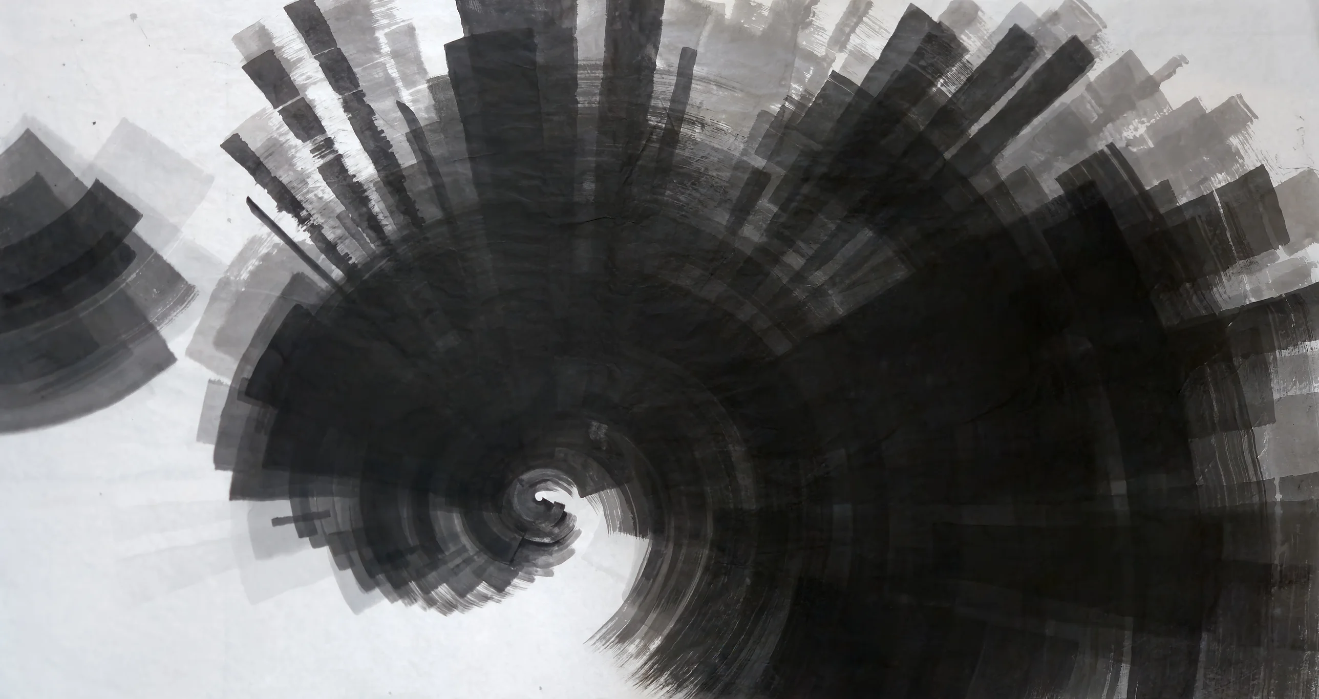 A large black spiral of radiating grey brush bands fills centre and right, with a smaller grey fan at left, on white paper.