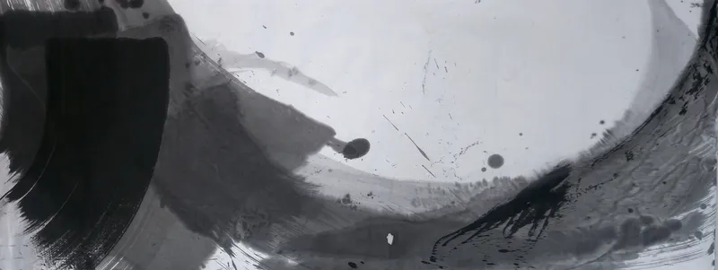 T_254: Wide ink painting: black block at left, grey sweep along the bottom curving up the right edge around pale empty paper, with scattered drops.